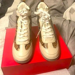White and snake skin sneaker wedges.